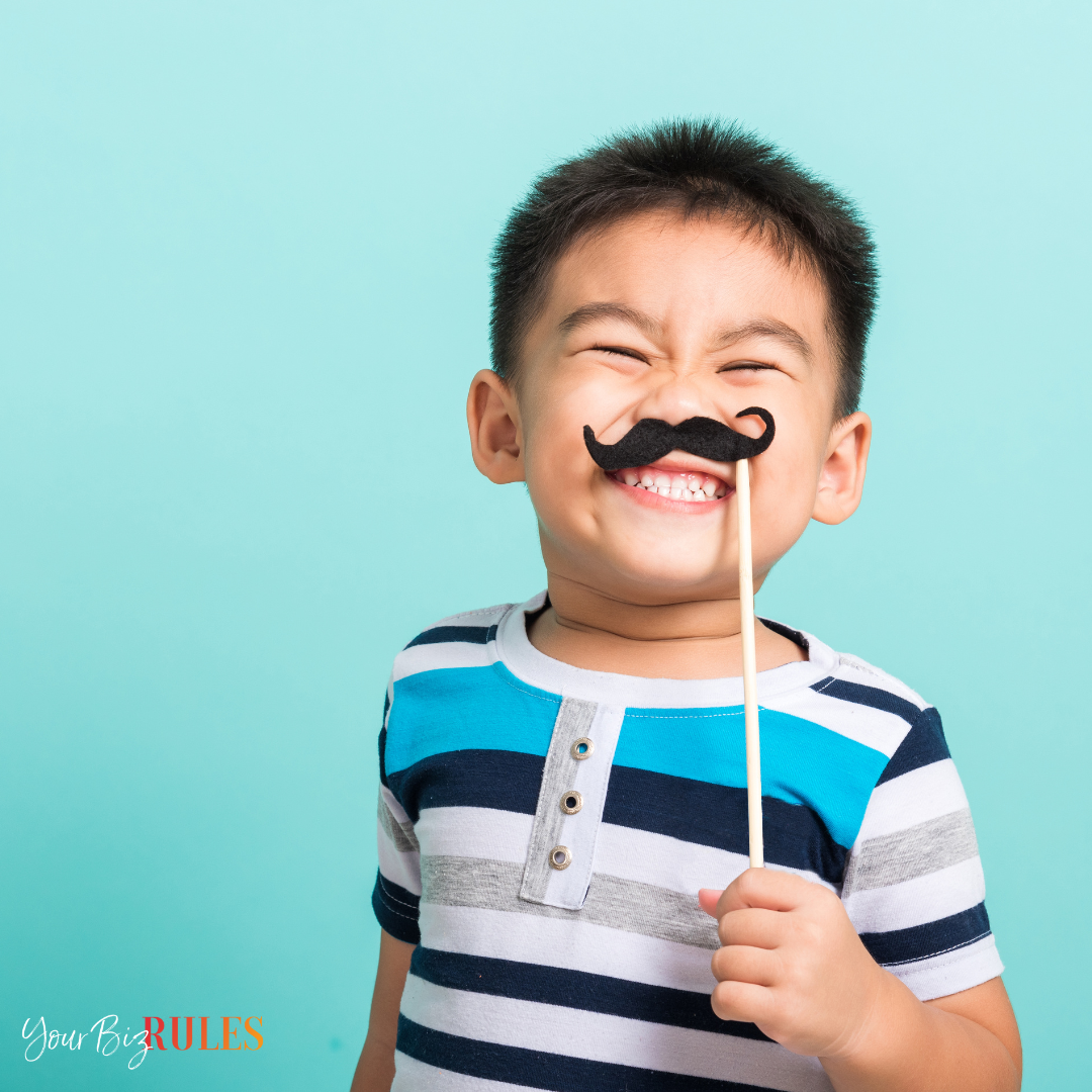 A kid pretending to have a mustache.